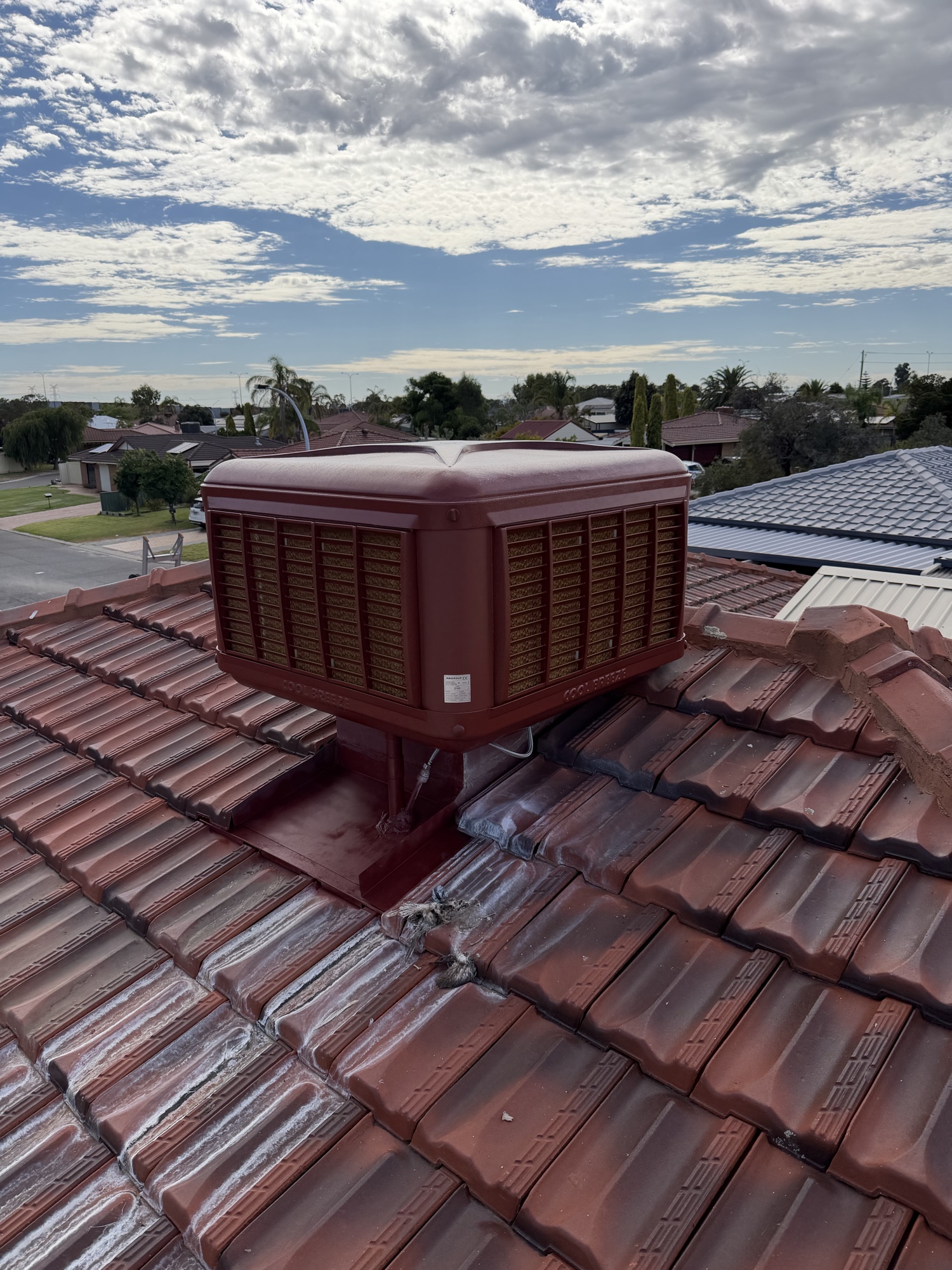 Evaporative air conditioner on a Perth tile roof